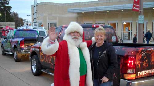 Santa with truck delivering toy drive.